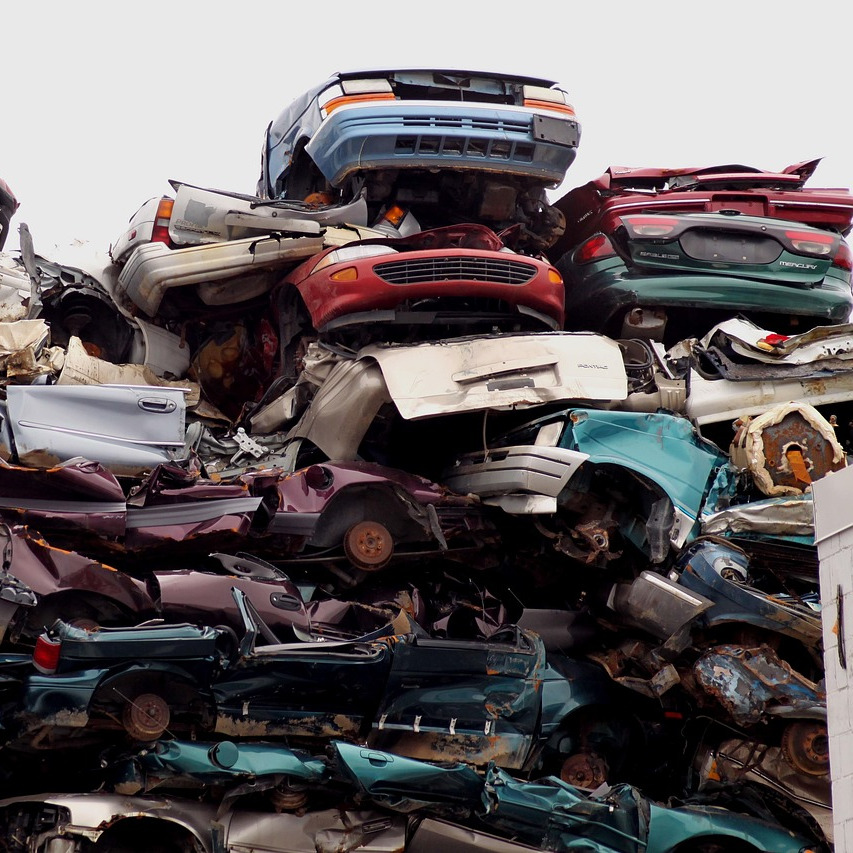 auto salvage yard staff pulling parts